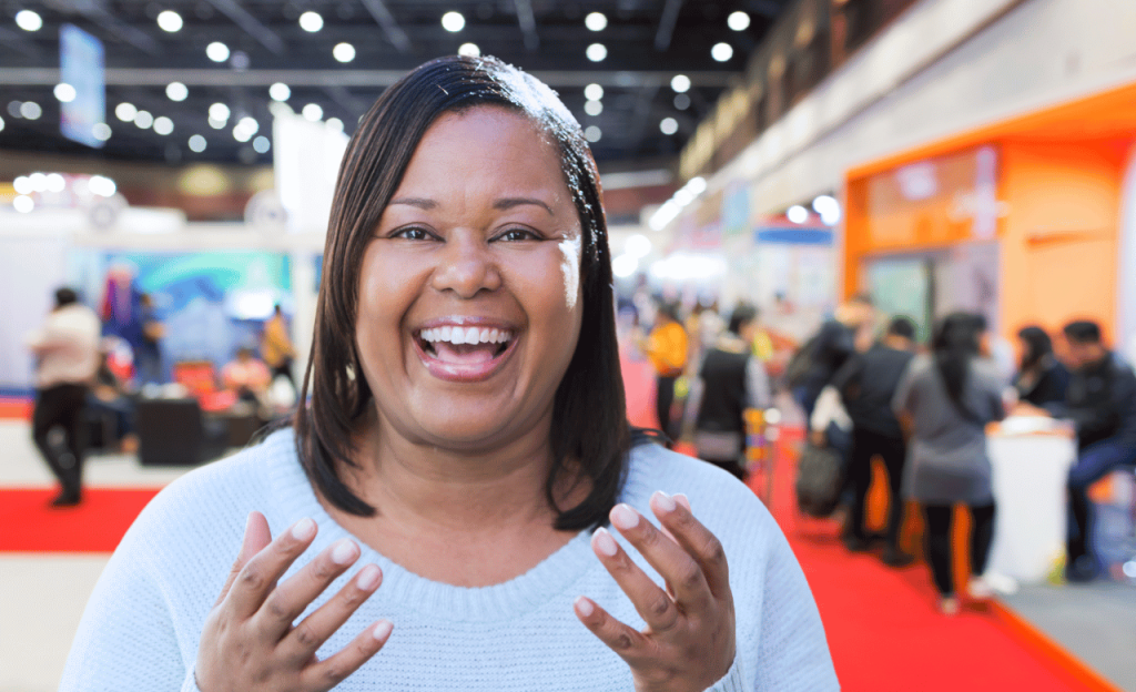 Woman giving a video testimonial at a corporate event.